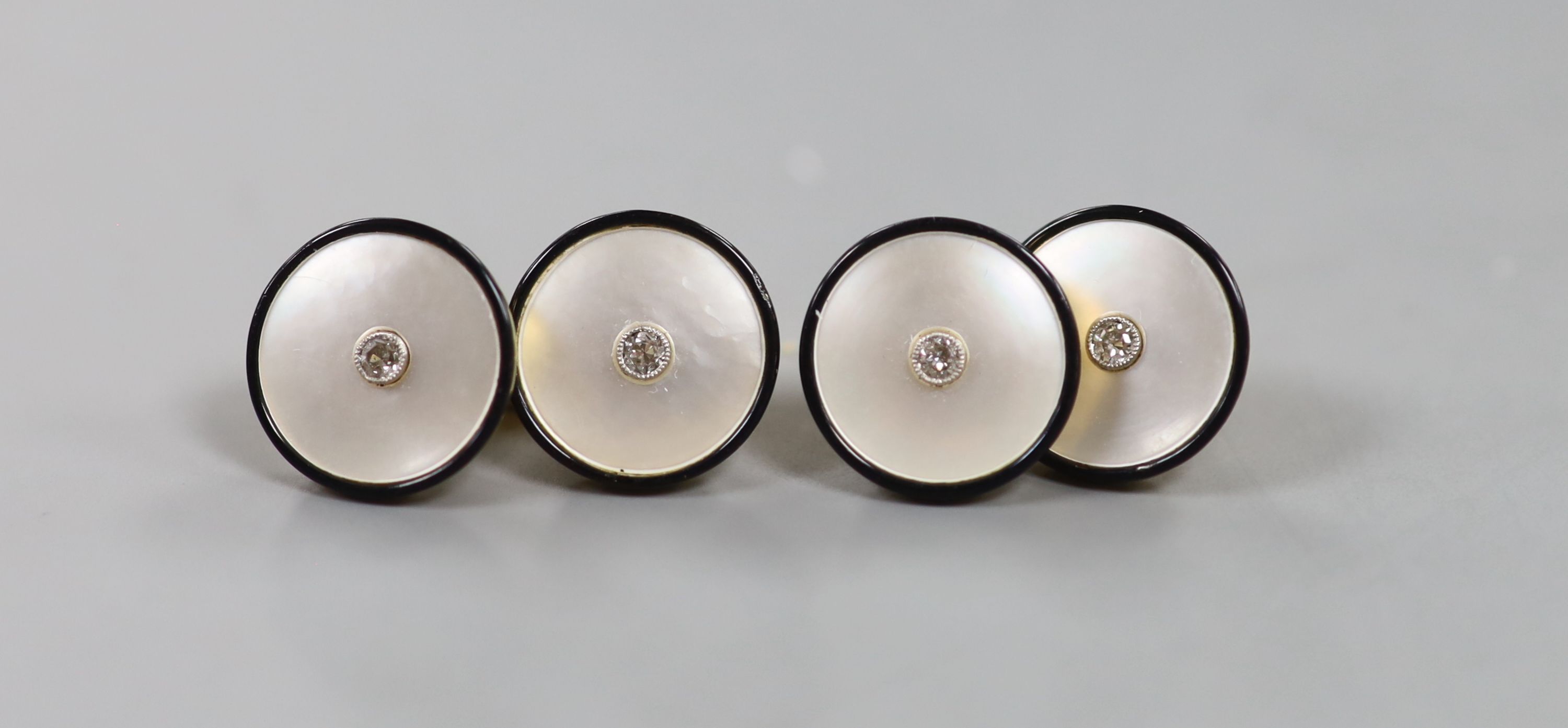A cased pair of 18ct, mother of pearl, black enamel and diamond set circular cufflinks